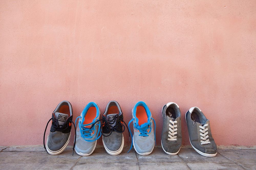Sneakers lying against the wall. Free public domain CC0 image.