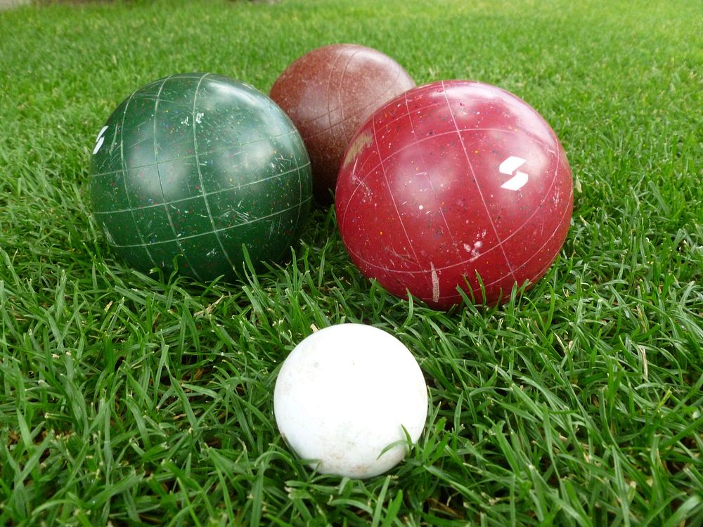 Closeup on bocce ball set on grass. Free public domain CC0 photo.