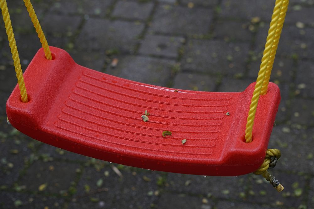 Swing in playground. Free public domain CC0 image.