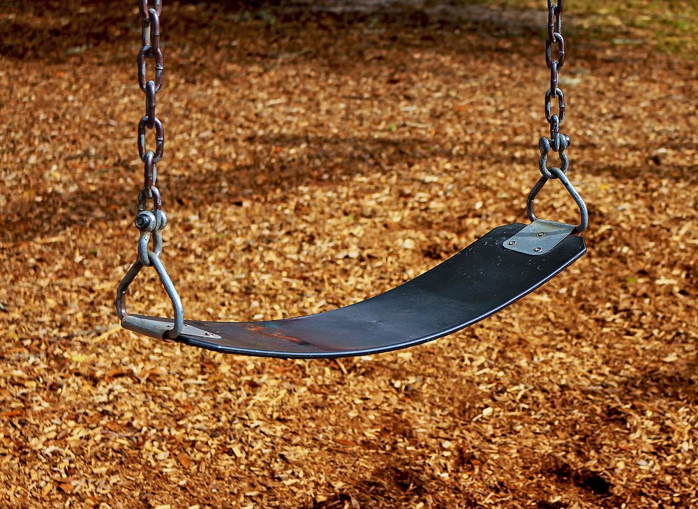 Swing in playground. Free public domain CC0 image.