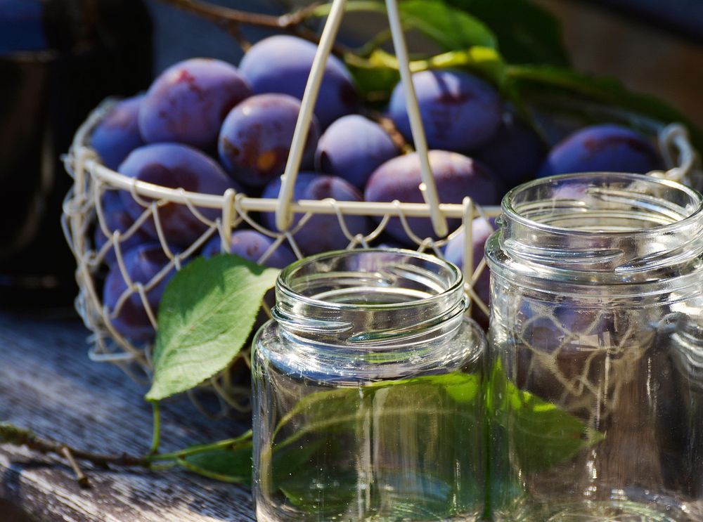 Closeup on fresh plums in bowl on table. Free public domain CC0 photo.