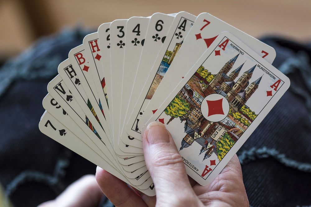 Hand of cards, gambling addiction. Free public domain CC0 photo.
