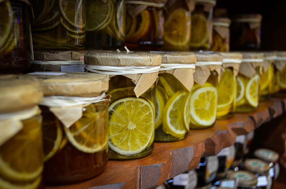 Preserved lemons in jars on rack. Free public domain CC0 image.  