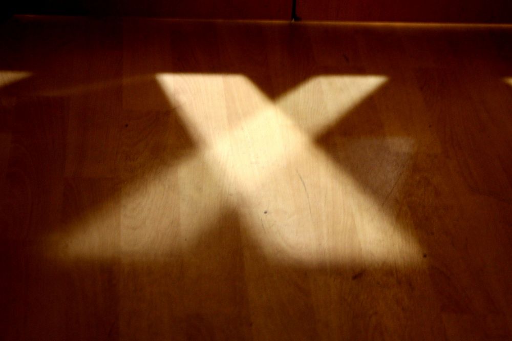 Sunlight cross ray on wooden floor. Free public domain CC0 image.