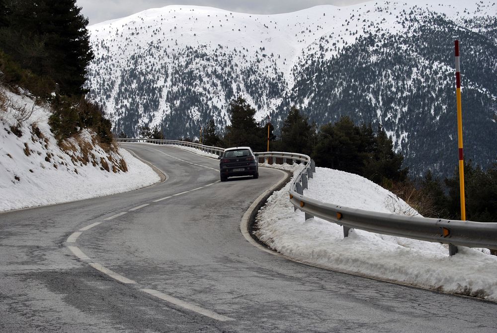 Curvy road along snow mountain. Free public domain CC0 photo.