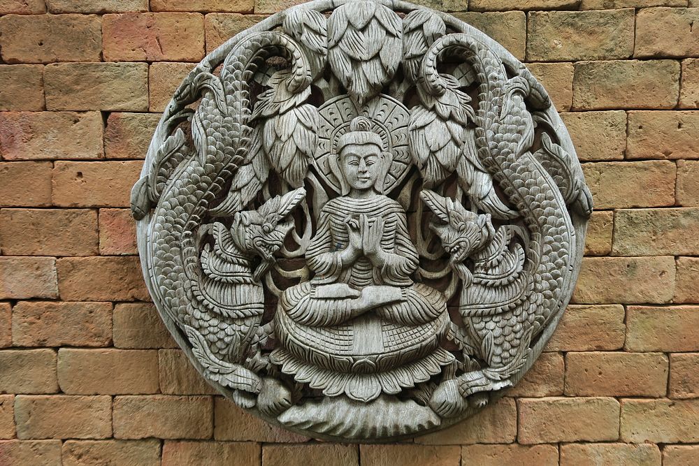 Buddha wall craving background. Free public domain CC0 image.