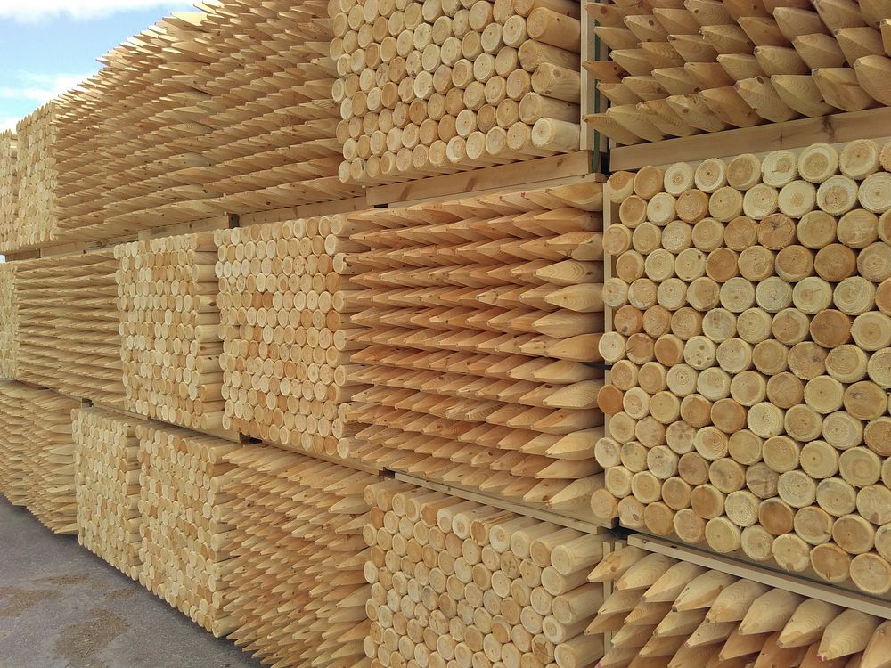 Stacks of wooden poles. Free public domain CC0 image.