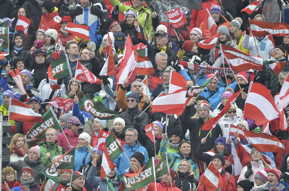 G&ouml;sser & Kleine Zeitung sponsor on flag held by Austrian sport spectators, Schladming, March 5, 2013. View public…