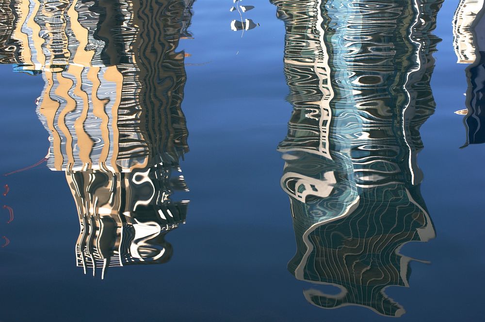 Reflection of buildings on water. Free public domain CC0 image.
