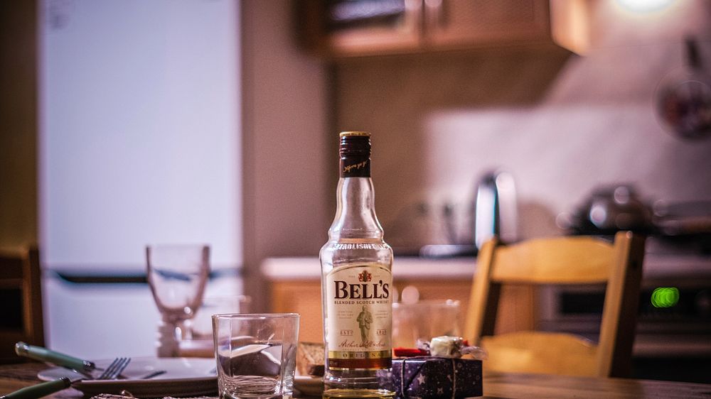 Bell's, whiskey bottle on a table in kitchen, location unknown, date unknown