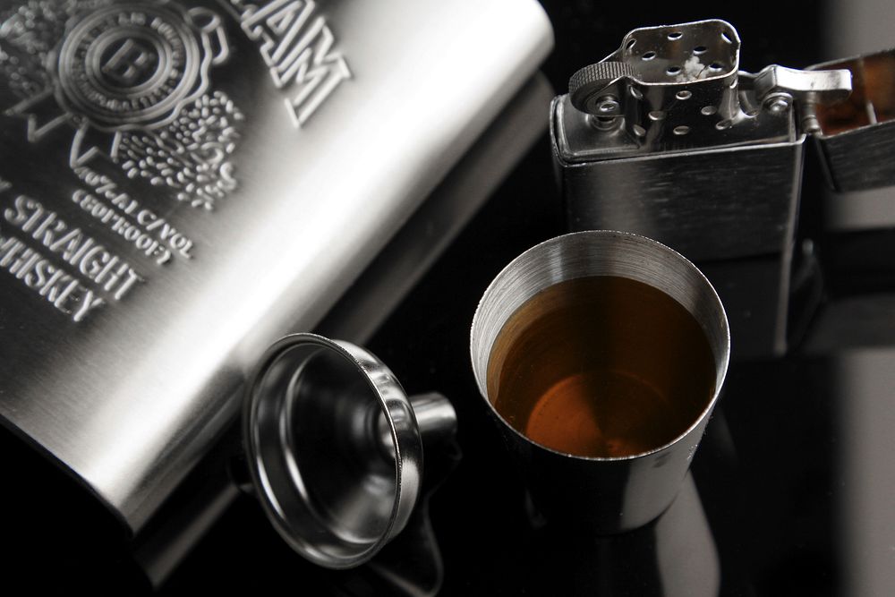 Whiskey flask and lighter. Free public domain CC0 photo.
