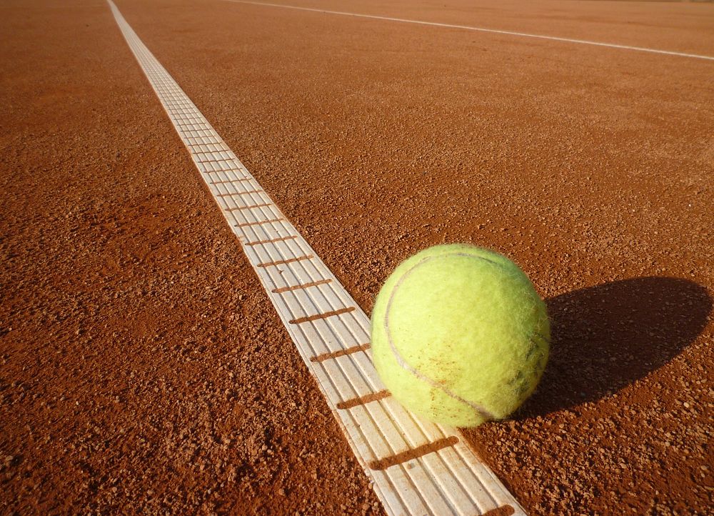 Tennis ball on court. Free public domain CC0 photo.