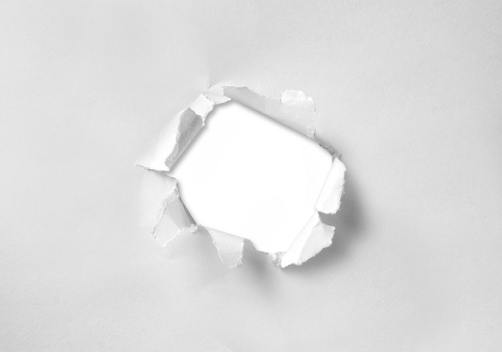 A hole torn through paper on white background. Free public domain CC0 image.