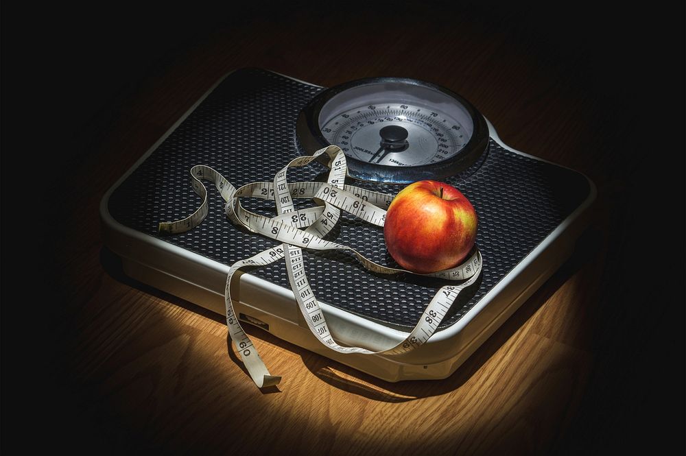 Free measuring tape and an apple on a weighing scale, public domain diet and fitness CC0 photo.