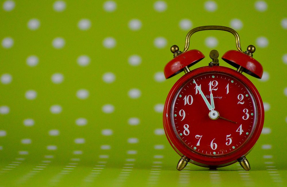Red alarm clock, timepiece. Free public domain CC0 photo.
