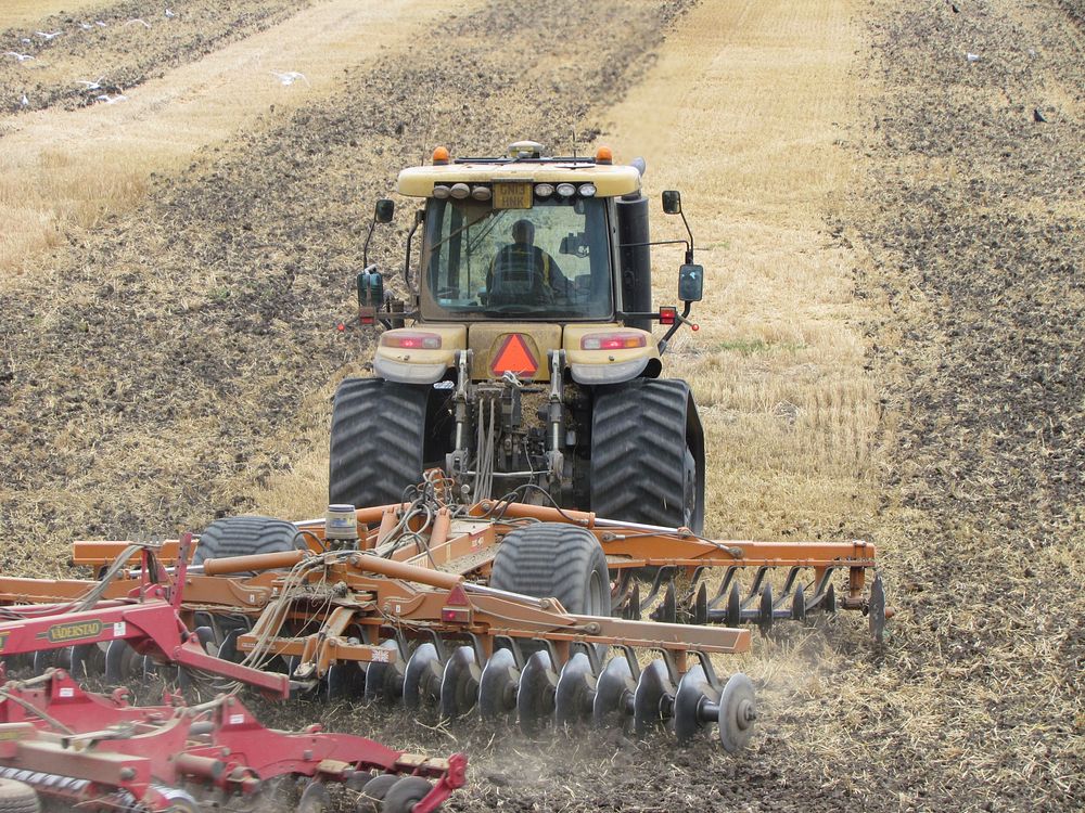 Farm plowing tractor vehicle. Free public domain CC0 photo.