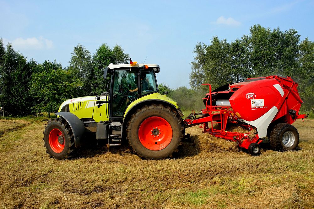 Claas 640 Arion tractor with Lely round baler, Location unknown, July 24, 2016.