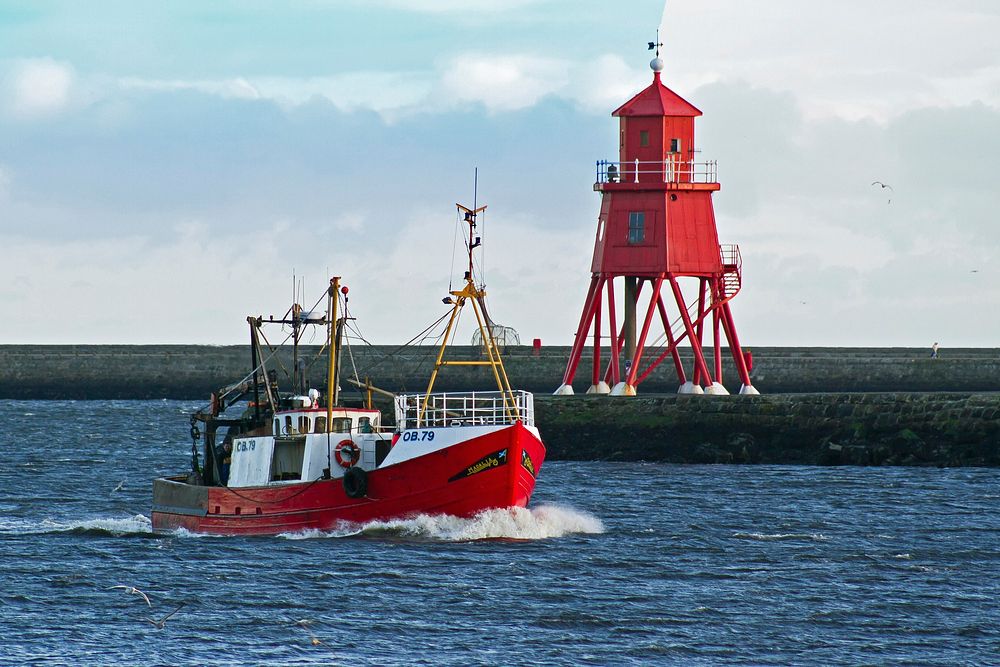 Red electric fishing boat sailing. Free public domain CC0 photo.