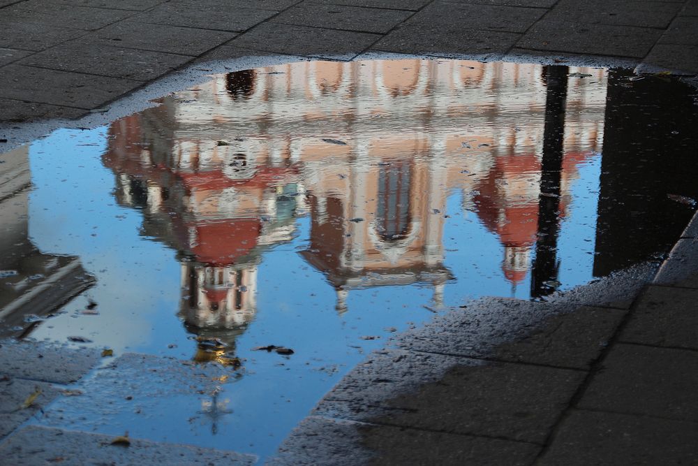 Building reflection on water puddle. Free public domain CC0 photo.