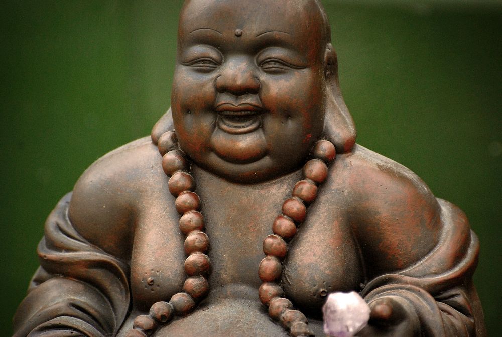 Laughing Buddha statue background. Free public domain CC0 image.