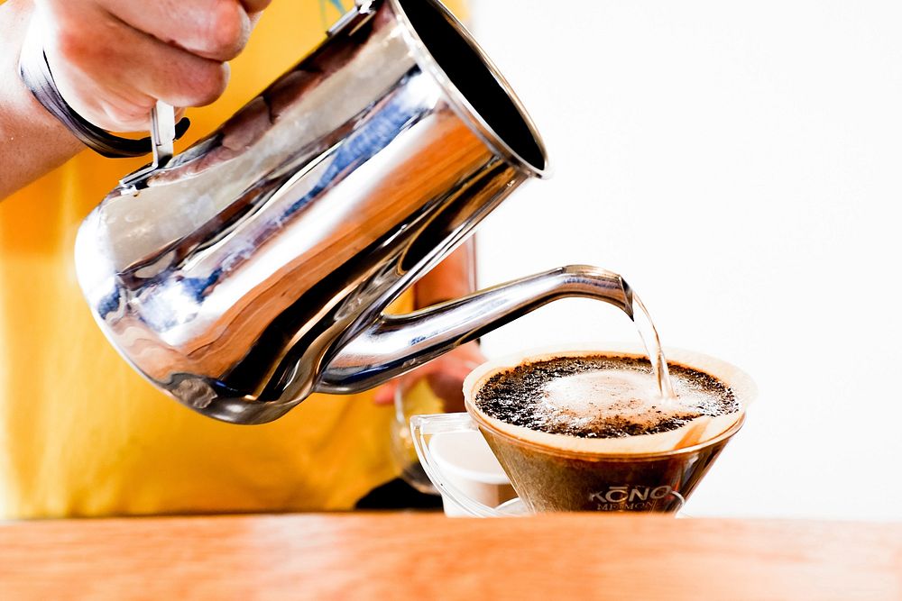 Free man pouring hot water into coffee cup photo, public domain beverage CC0 image.