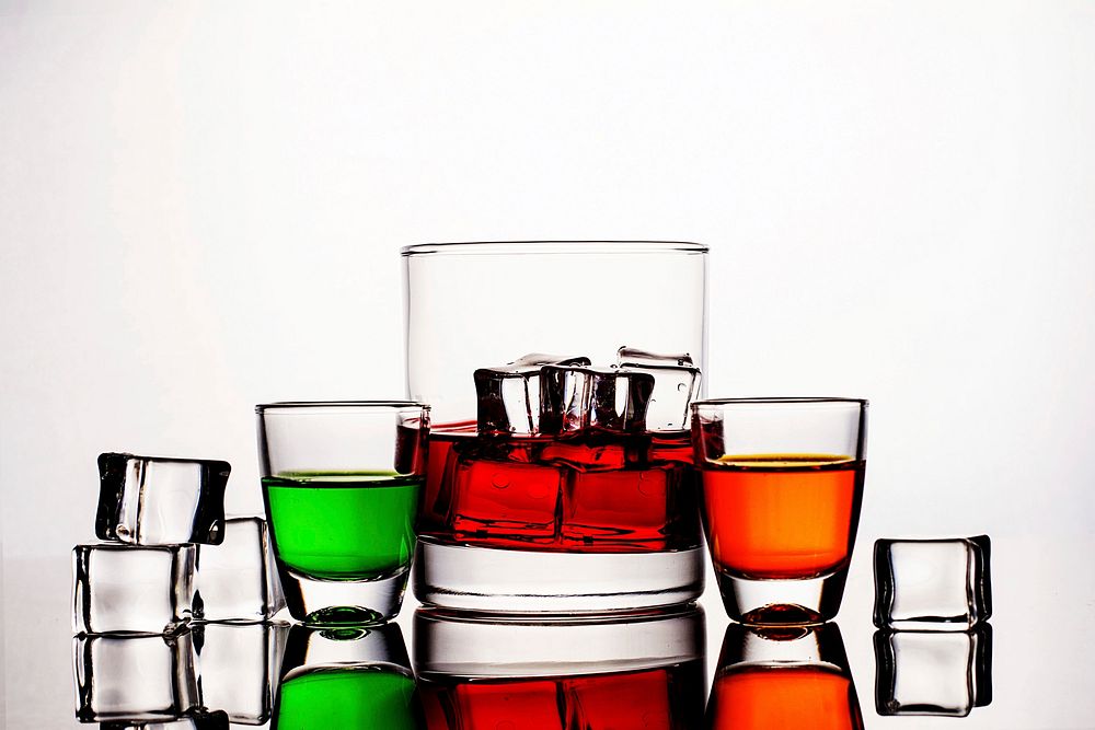 Free party liquors in glasses with ice cubes on white background photo, public domain beverage CC0 image.