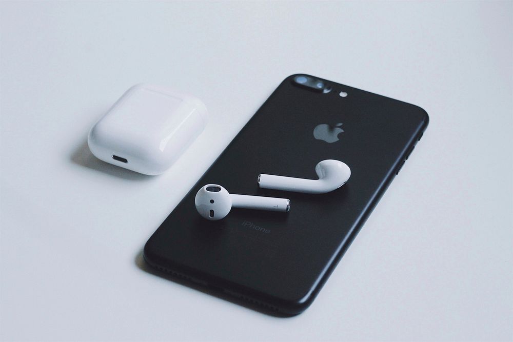 Apple iPhone with airpods, digital device photo, location unknown, date unknown.