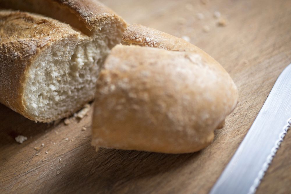 Free slice baguette bread on wooden board image, public domain food CC0 photo.