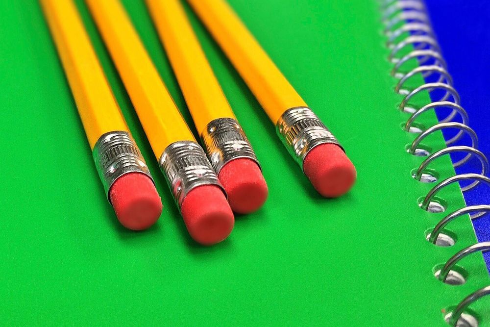 Free school pencils on notebook image, public domain CC0 image.