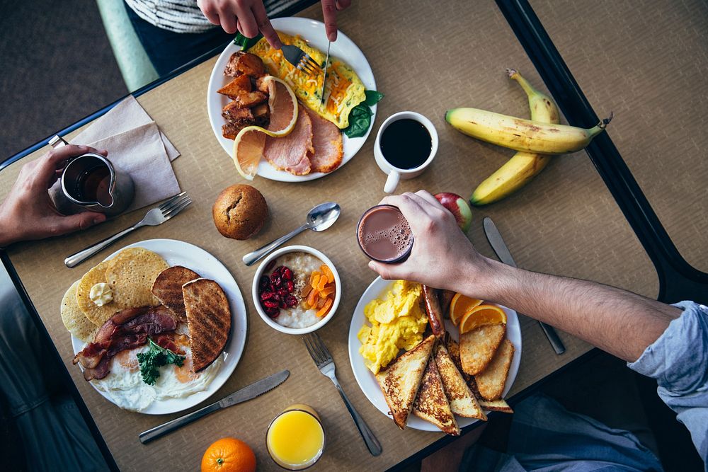 Free three people at table with breakfast, public domain food CC0 image.