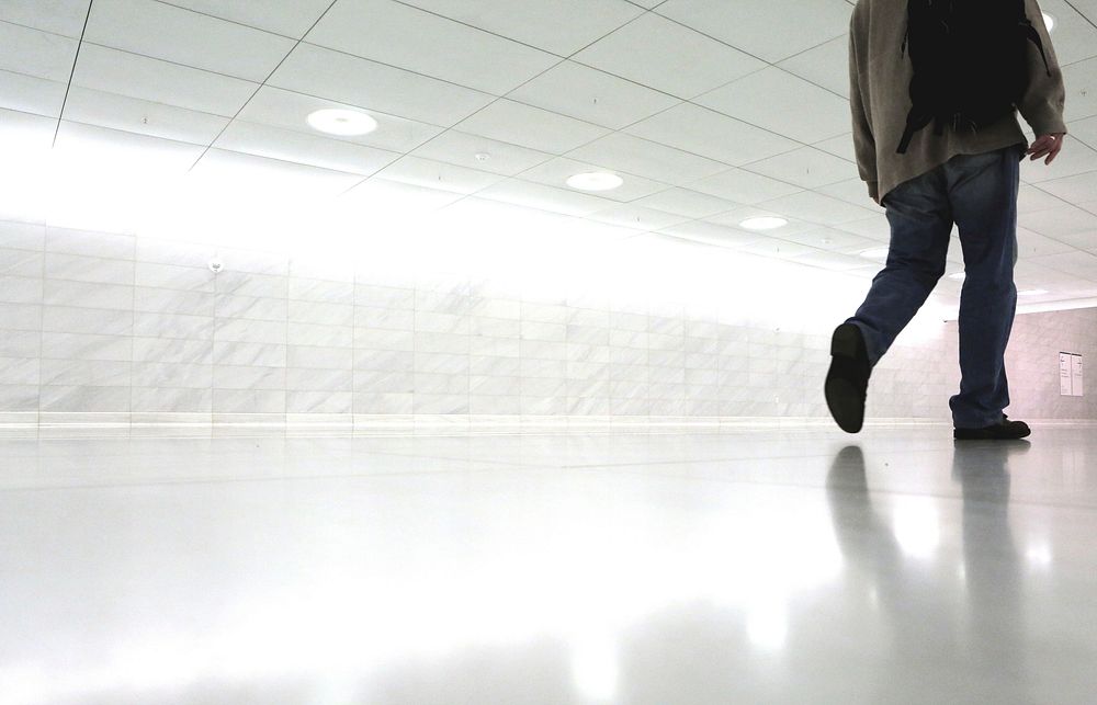 Free man walking in white room image, public domain human CC0 photo.