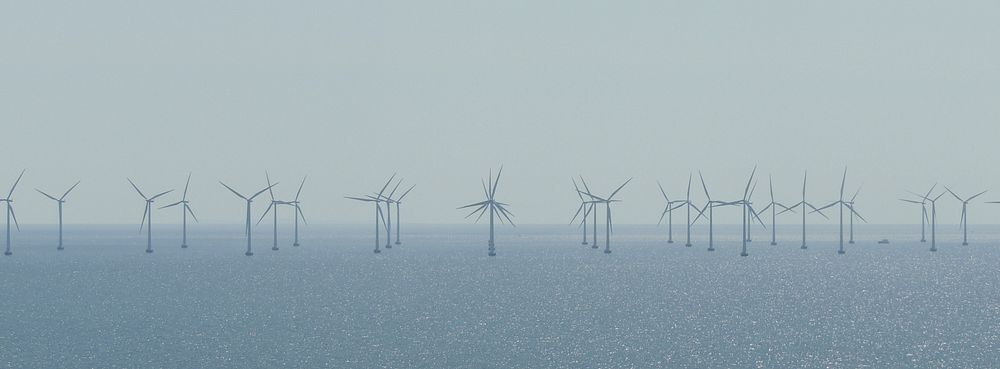 Wind farm in misty background image, public domain CC0 photo.