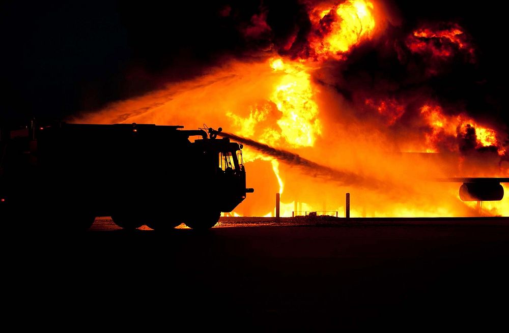 Free firetruck spraying water on fire image, public domain CC0 photo.
