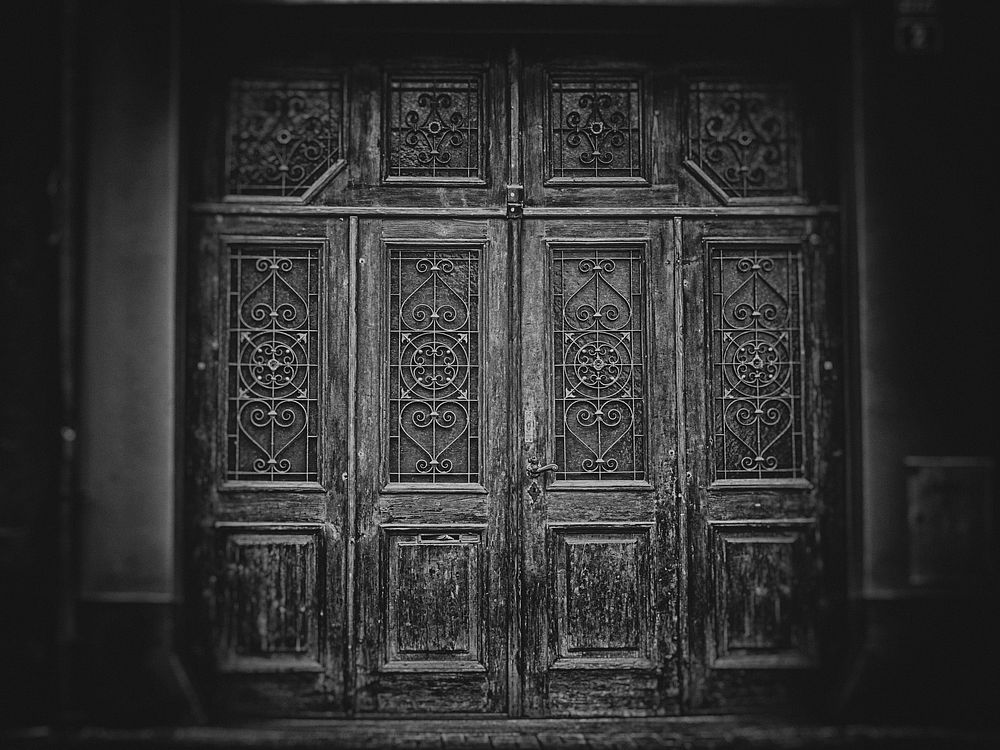 Free ancient door, black and white photo, public domain gray CC0 image.
