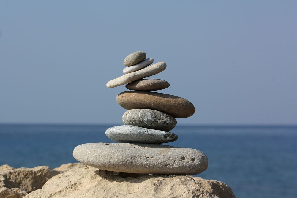 Stack pebbles stone on beach, free public domain CC0 photo.