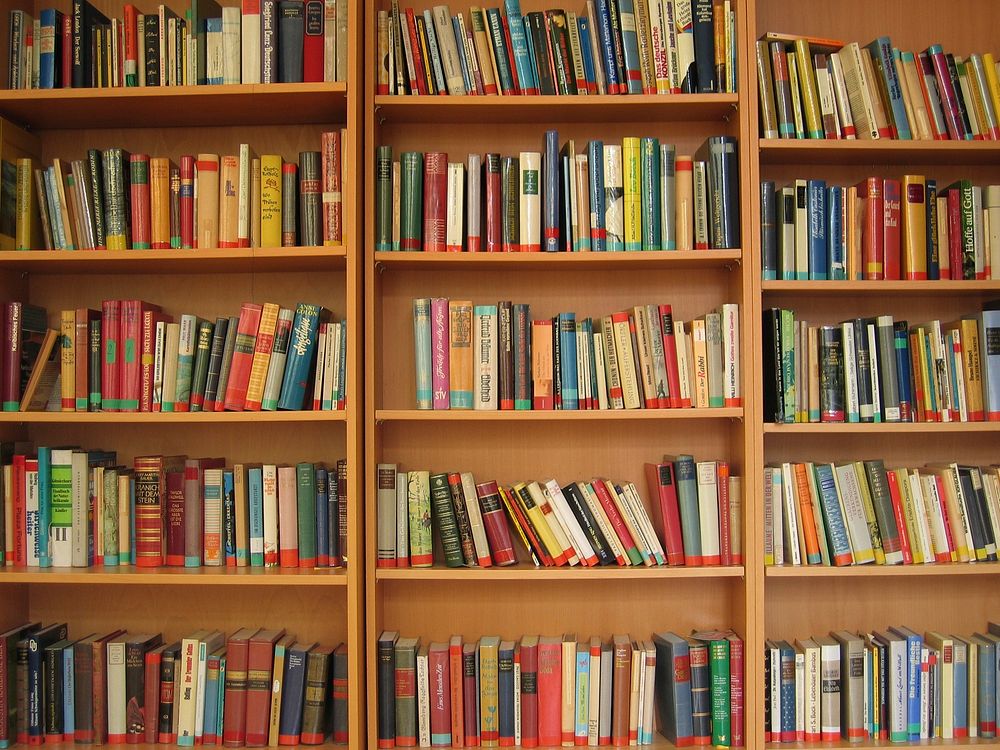 Free colorful books in shelves image, public domain CC0 photo.