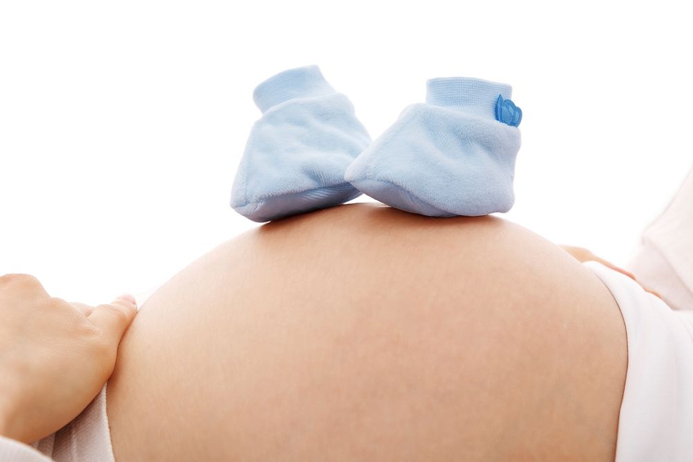 Free pregnant woman with baby shoe image, public domain love CC0 photo.