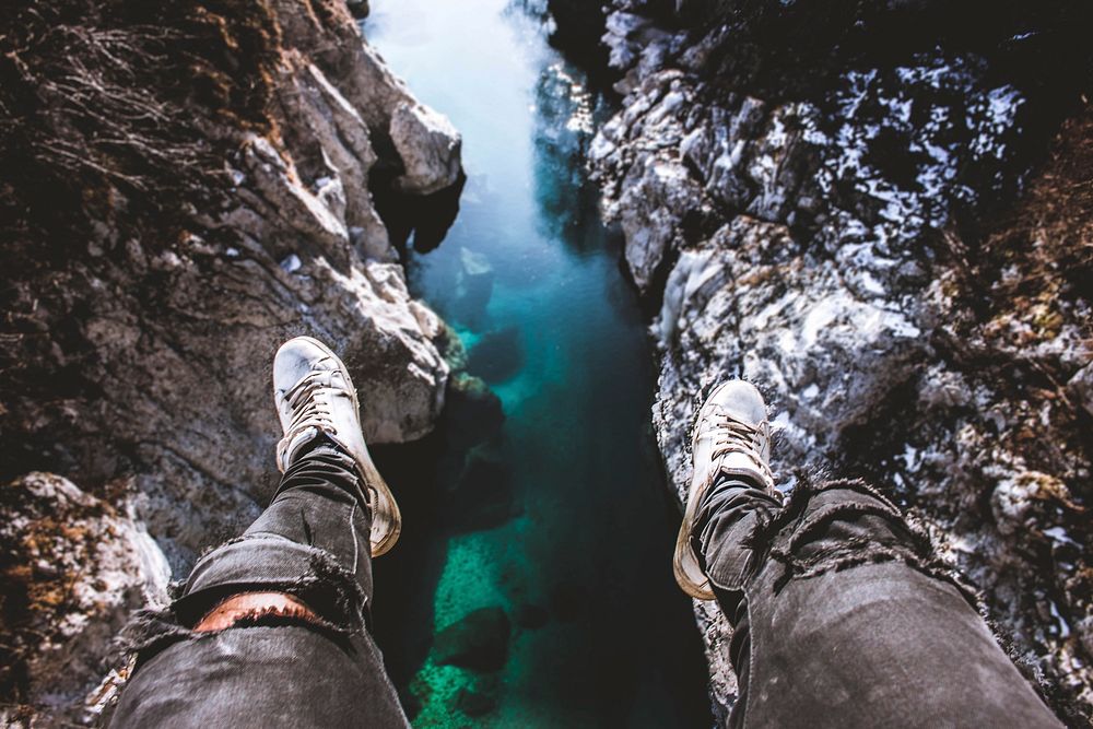 Free man sitting on edge of a cliff image, public domain nature CC0 photo.