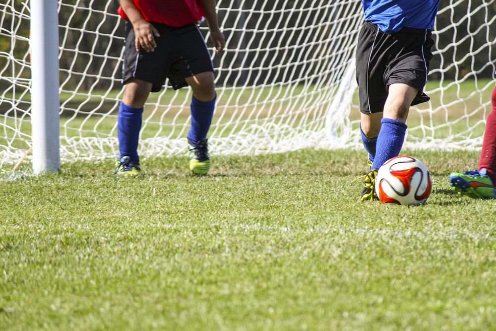 Free men playing a soccer game on field image, public domain sport CC0 photo.