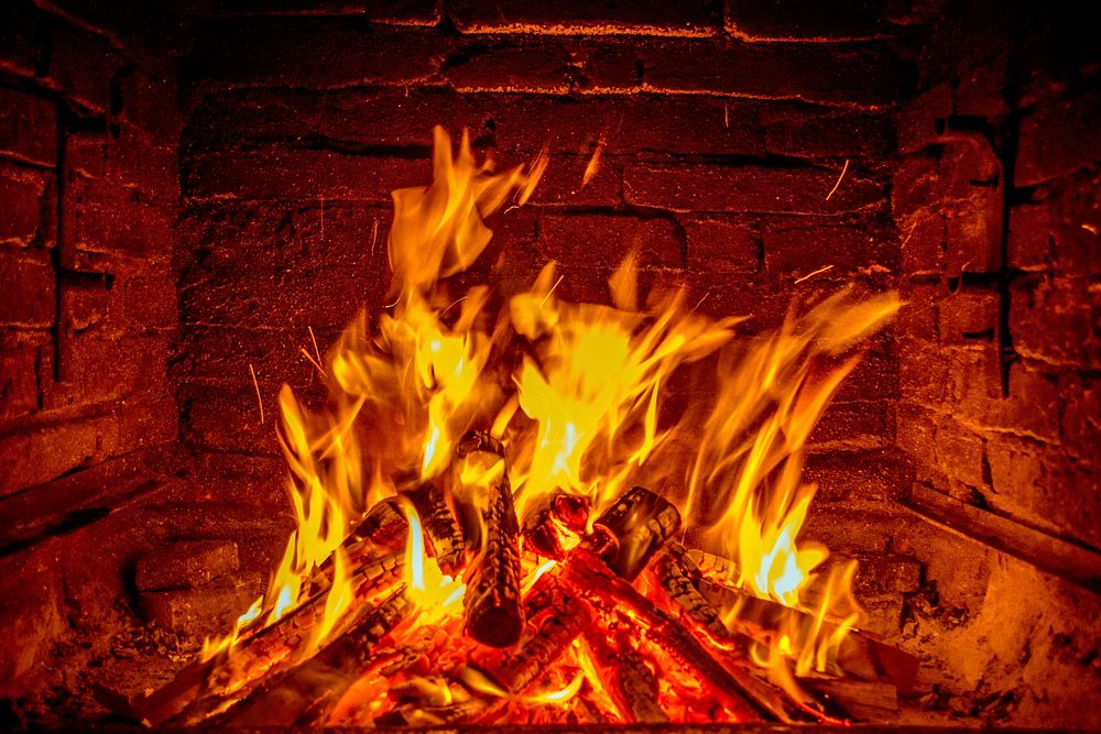 Burning logs in fireplace. Free public domain CC0 photo.
