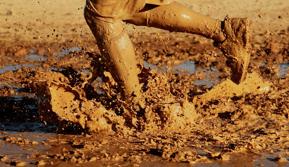 Free child legs in mud, closeup photo, public domain CC0 image.