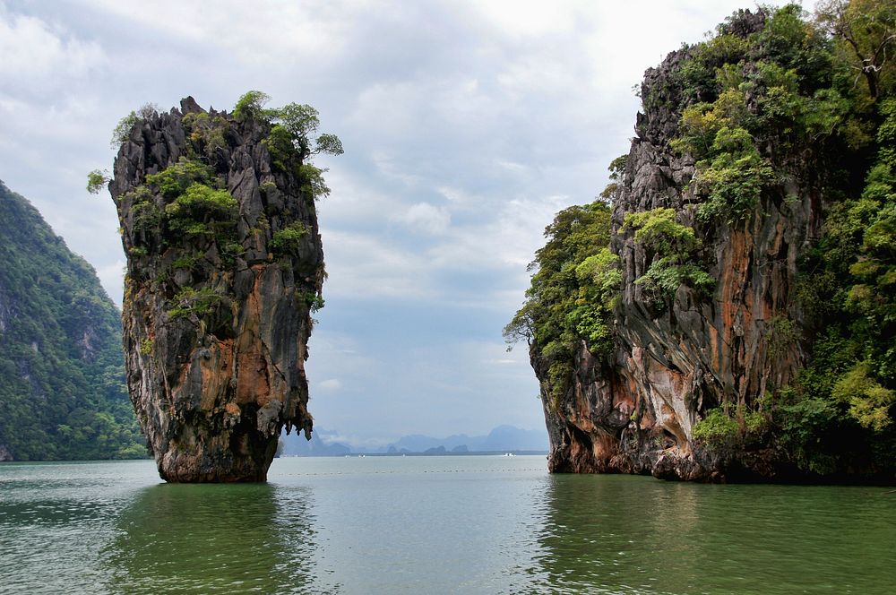 Island with cliff, rocks, caves, free public domain CC0 photo.