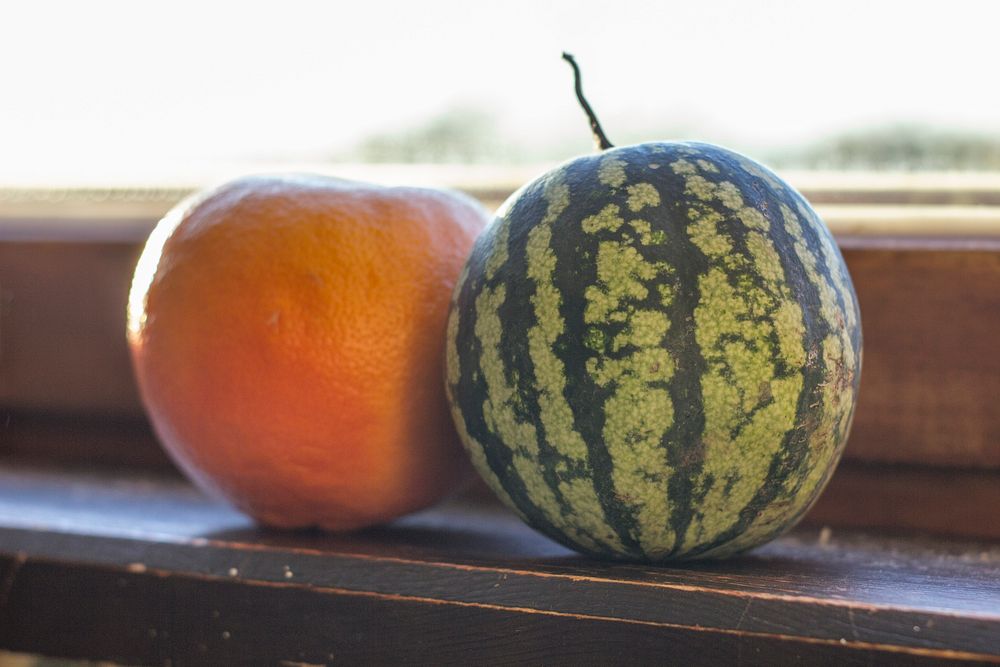 Free watermelon next to an orange fruit image, public domain CC0 photo.