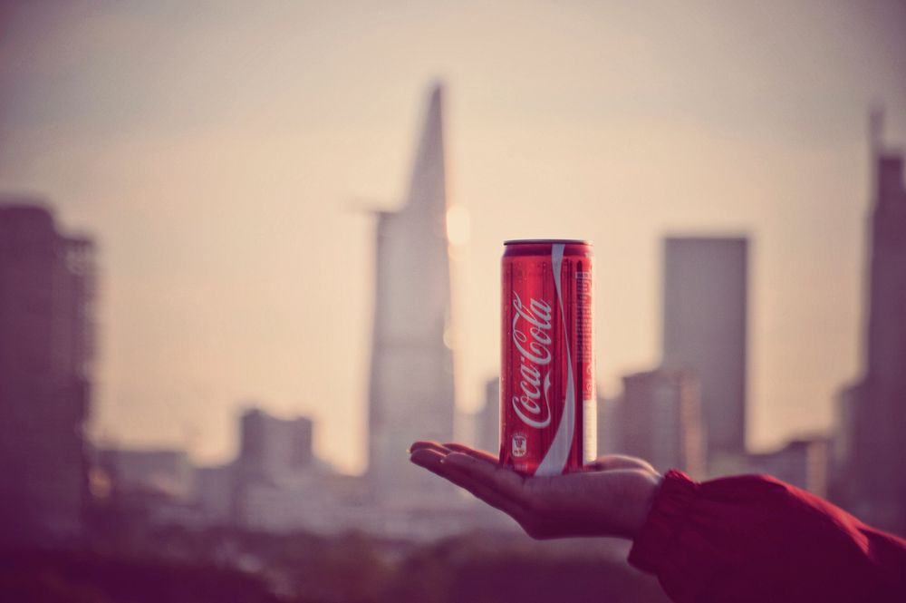 Coke can on a hand with cityscape, Vietnam, 28/10/2018