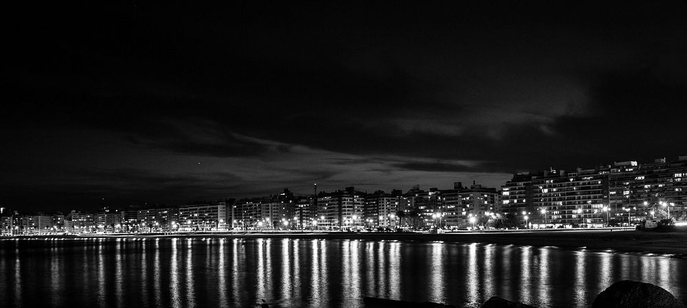 Free town along the beach at night in black and white image, public domain CC0 photo.