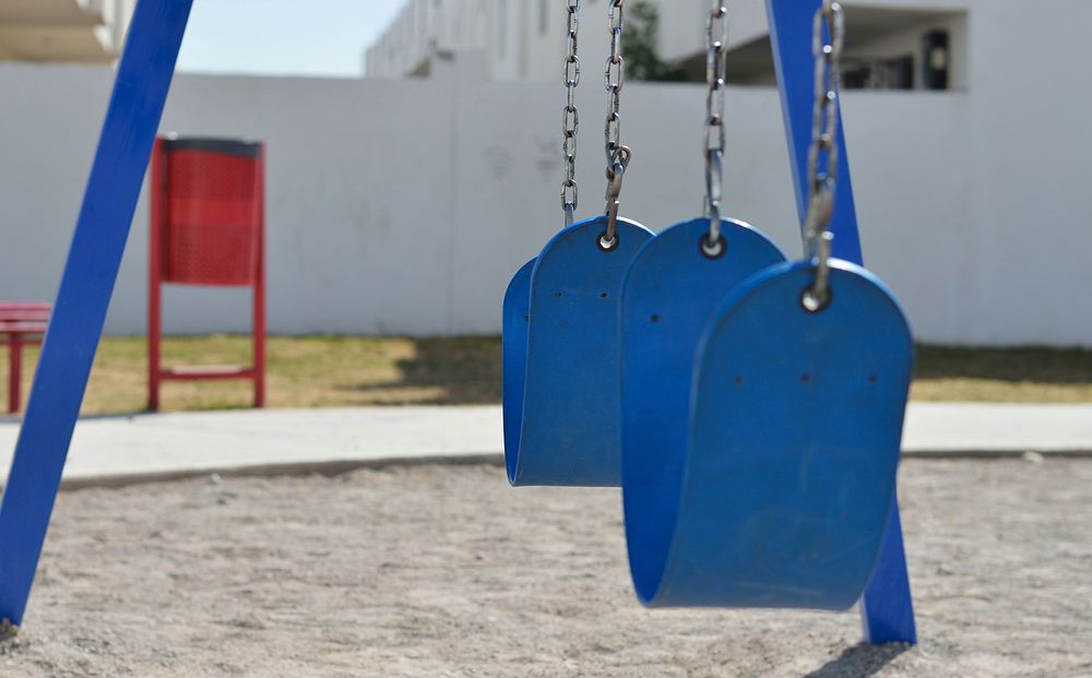 Swing in playground. Free public domain CC0 image.
