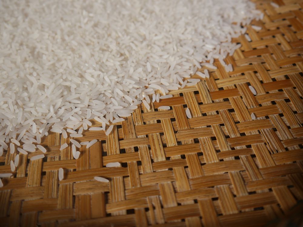 Free uncooked rice grain on the mat public domain CC0 photo.