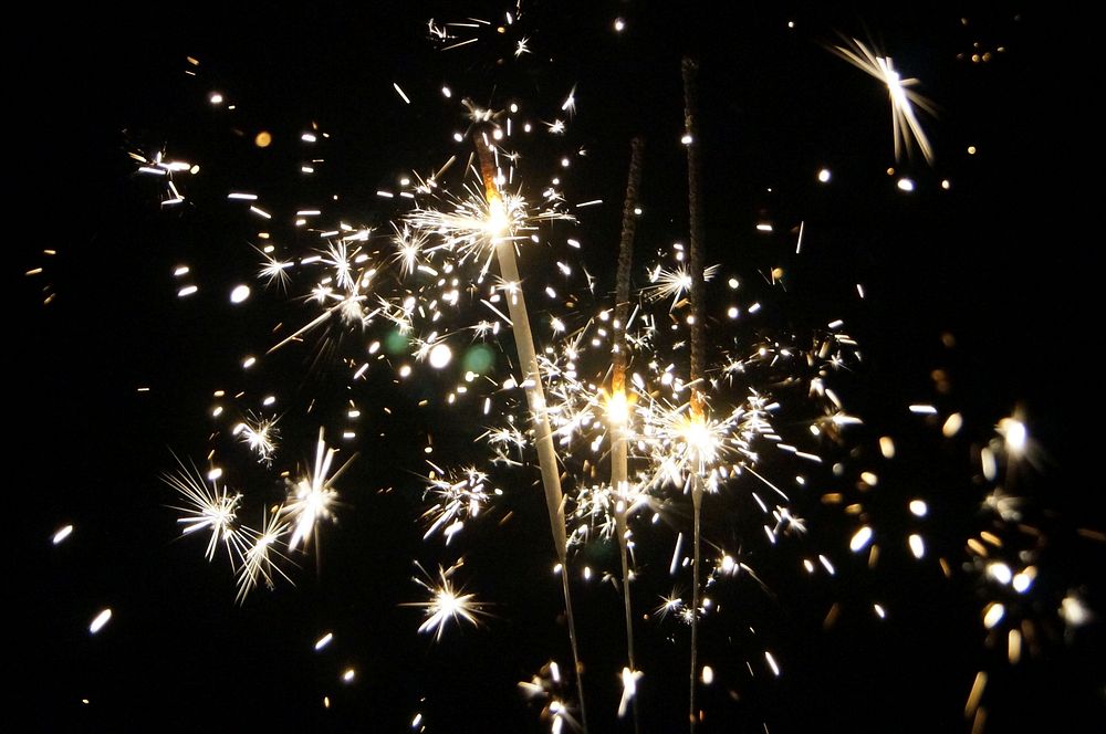Free burning sparklers on a black background image, public domain CC0 photo.