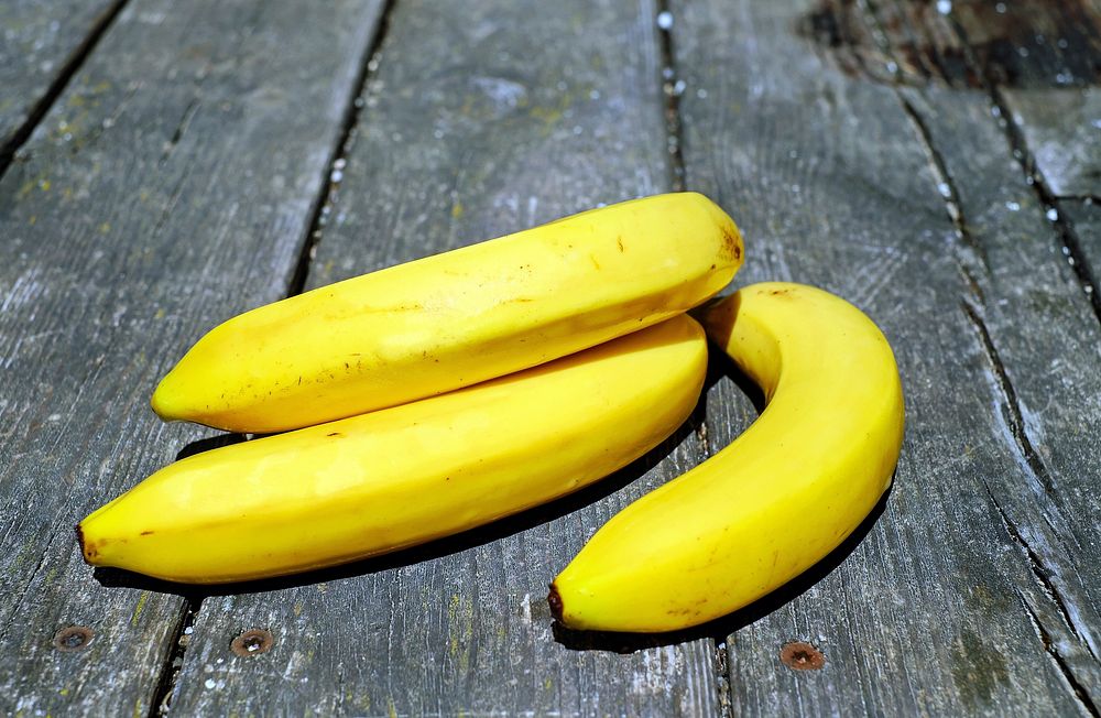 Free brunch of banana on a wooden table image, public domain CC0 photo.