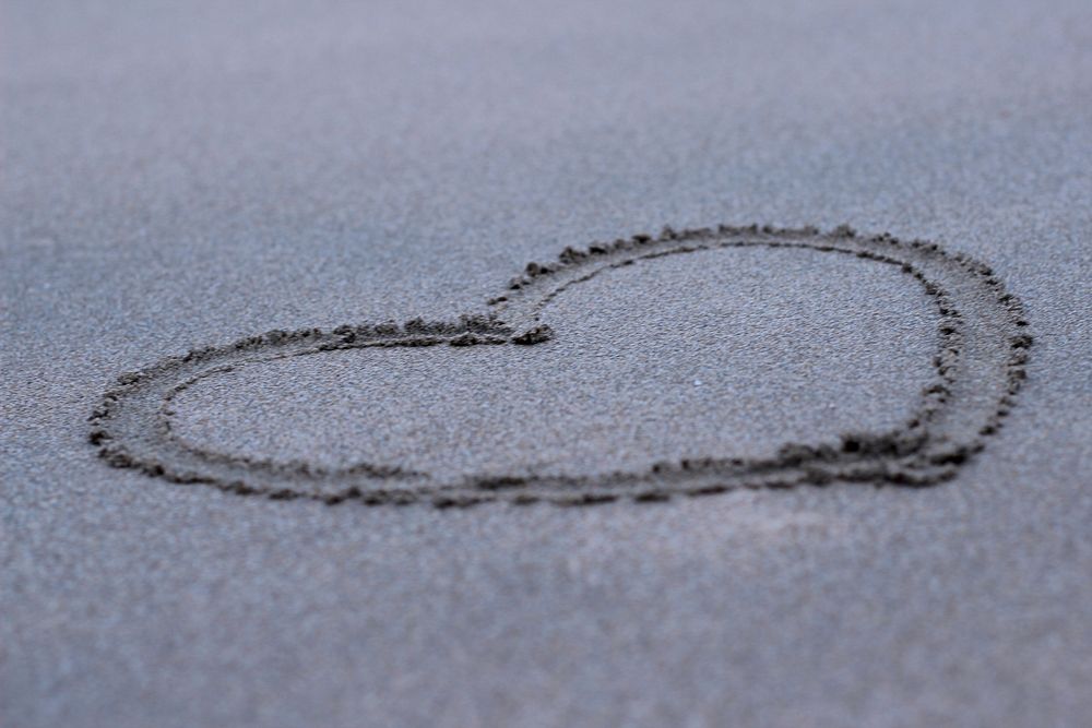 Heart, love symbol on beach, free public domain CC0 photo.
